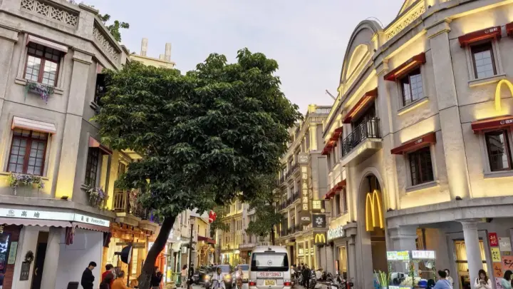 Evening streetscape in Guangzhou Xiguan with historic arcade buildings and neighborhood food shops